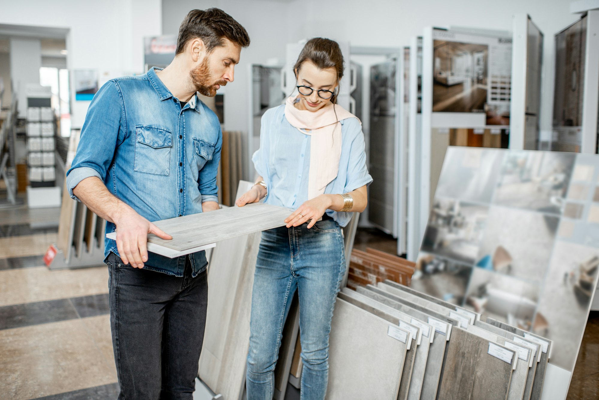 Couple choosing ceramic tiles in the shop